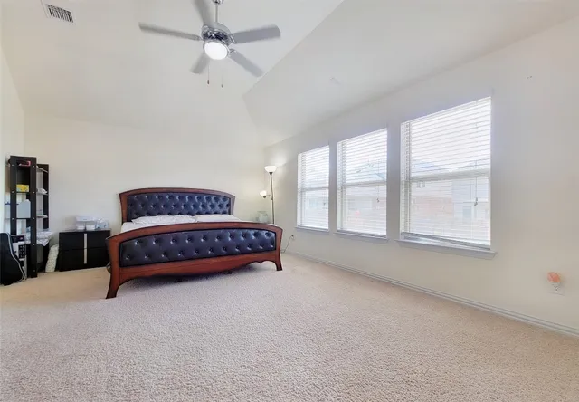 a bedroom with a bed and window