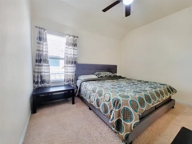 a bedroom with a bed and window