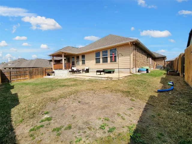 a front view of a house with a yard outdoor seating and garage