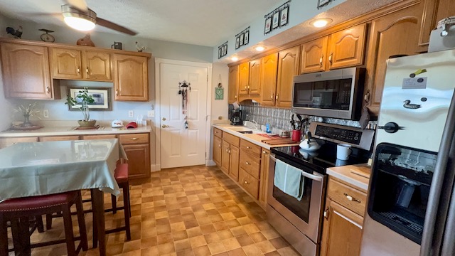 3361 Turner Drive Springfield, OH 45504 - Photo 8 of 18 This kitchen offers warm wood cabinetry, modern stainless steel appliances, and practical tiled flooring.