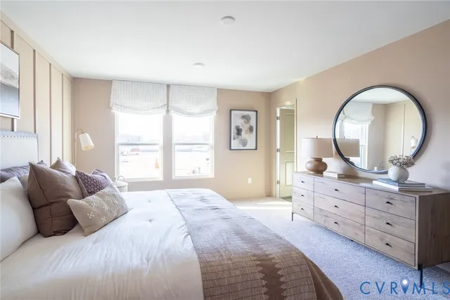 a bedroom with a large bed and a dresser