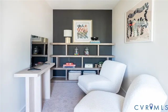 a living room with furniture a air conditioner and a window