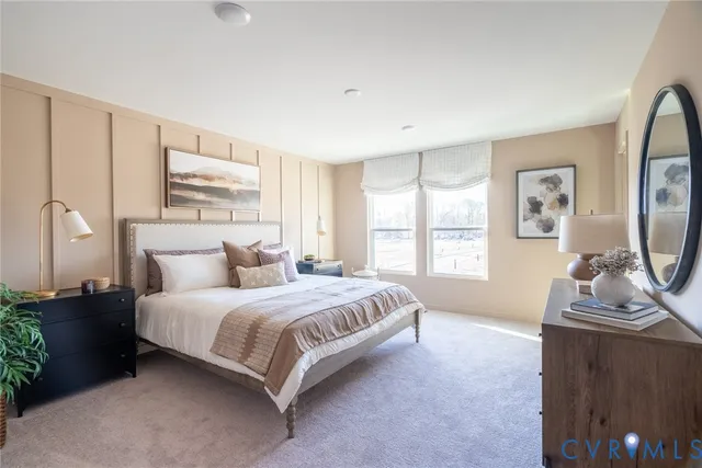 a living room with a bed furniture and a window