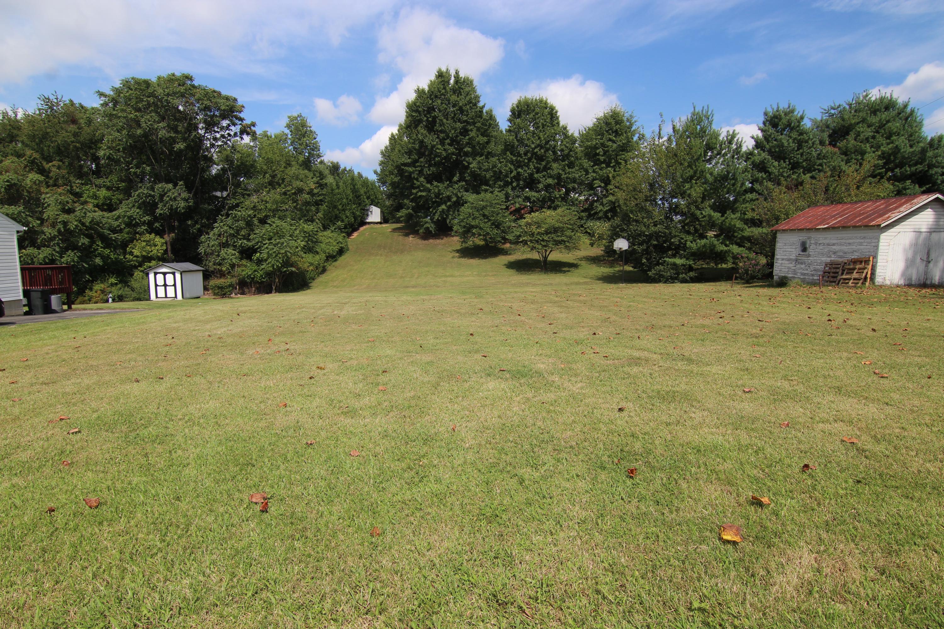 1118 Mountain View Road Vinton, VA 24179 - Photo 3 of 4 a tall yellow building with trees in the background