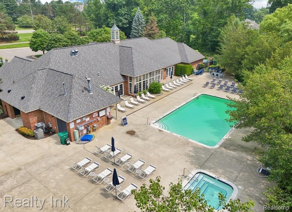 3399 Tremonte Circle Rochester, MI 48306 - Photo 13 of 14 Drone / aerial view of a pool and a tree filled landscape