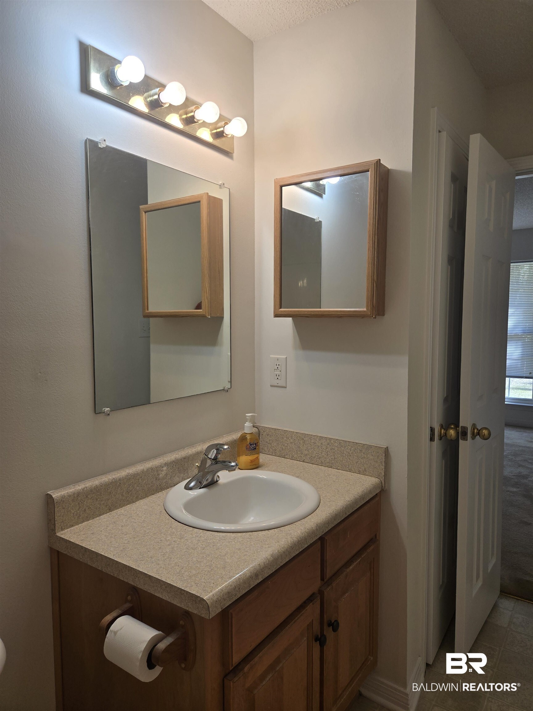 2554 Riverside Drive Mobile, AL 36605 - Photo 16 of 43 Bathroom with vanity, a textured ceiling, and light tile patterned flooring