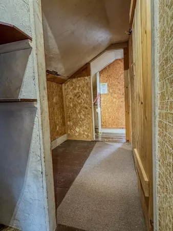 a view of a room with wooden floor and door