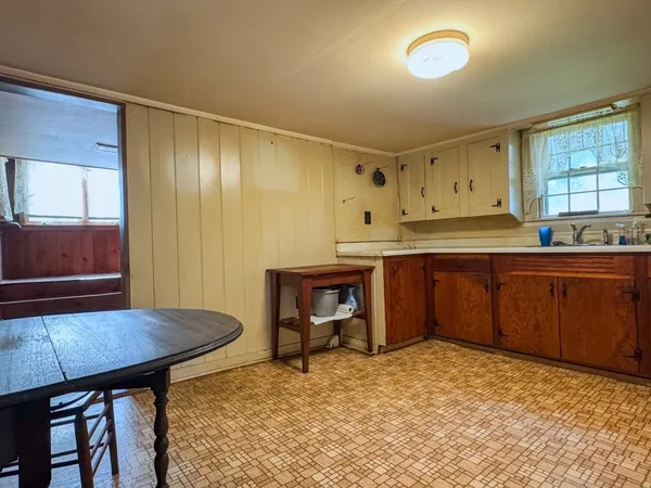 a kitchen with a stove a sink cabinets and wooden floor
