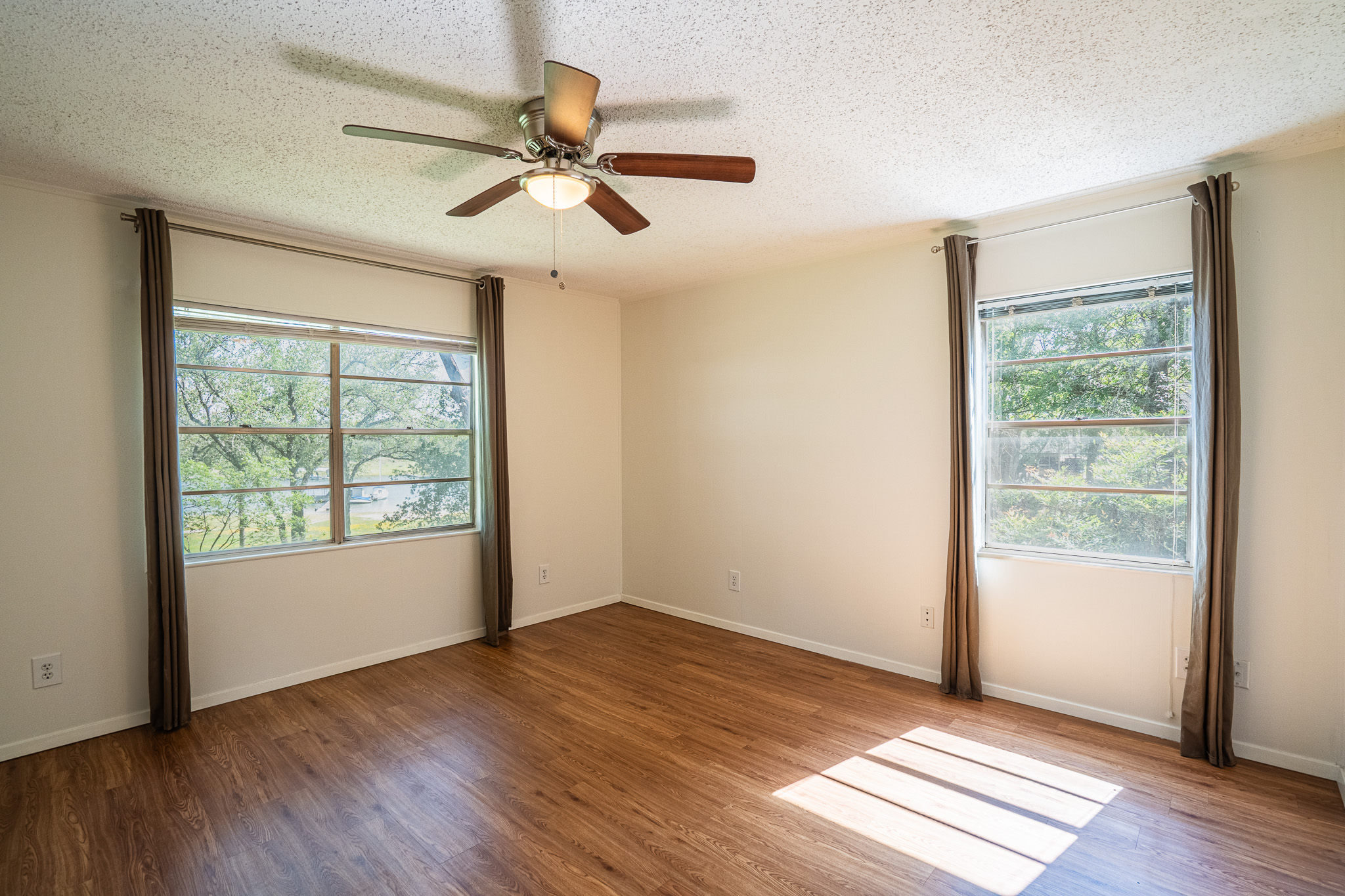 16013 Edwards Drive Austin, TX 78734 - Photo 12 of 18 Sun-filled room with wood flooring offers tranquil views through multiple windows.