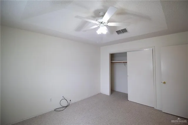 a view of a livingroom with a ceiling fan and window
