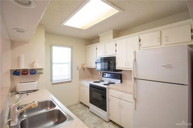 a kitchen with stainless steel appliances a refrigerator stove and microwave
