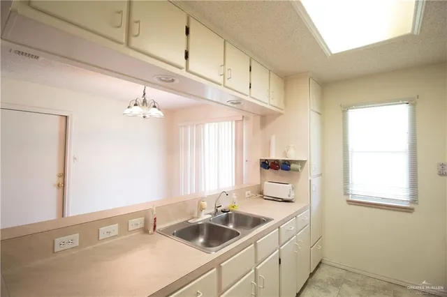 a bathroom with a sink and a window