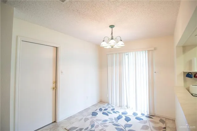 a view of a hallway to a bedroom with windows