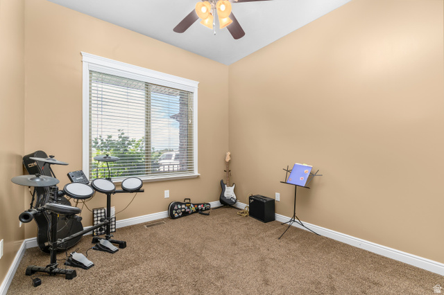 5702 950 North Ogden, UT 84404 - Photo 21 of 36 Carpeted interior room featuring a large window with horizontal blinds, a ceiling fan with integrated lighting, and crown molding