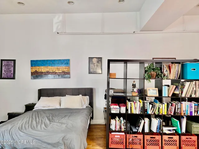 a bedroom with a bed furniture and a book shelf