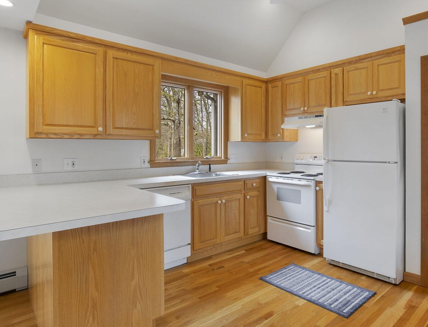 65 Whitney Road Eastham, MA 02642 - Photo 12 of 41 a kitchen with a refrigerator sink and cabinets