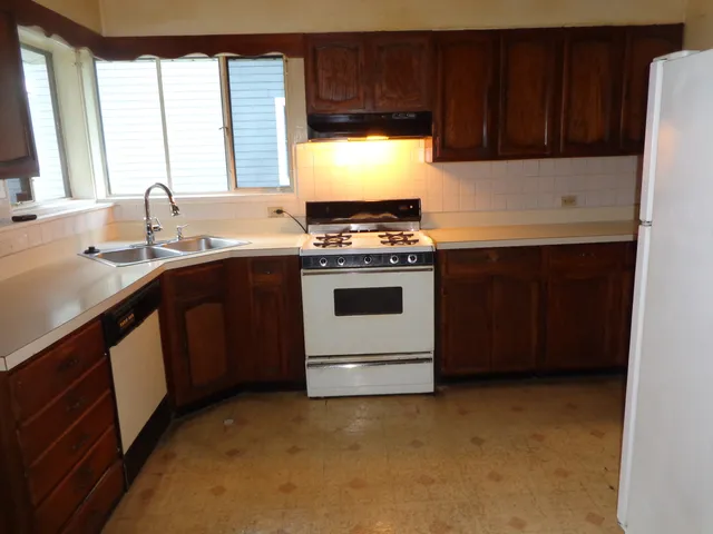 a kitchen with a stove and a sink