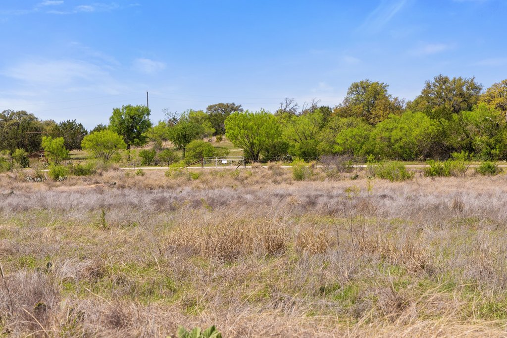 9580 Smith West Ranch Road Round Mountain, TX 78663 - Photo 16 of 26 a view of a dirt road and a building