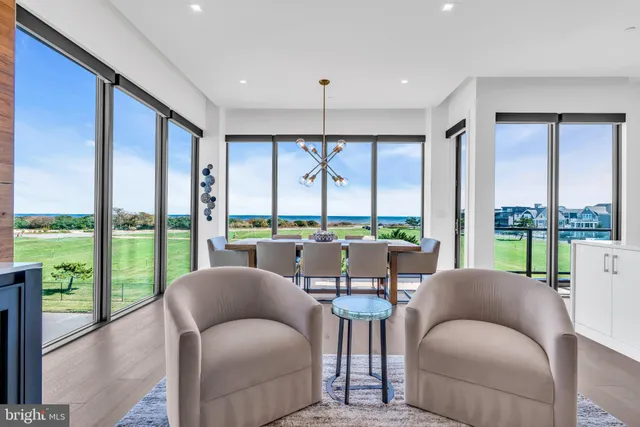 a living room with a large window and furniture