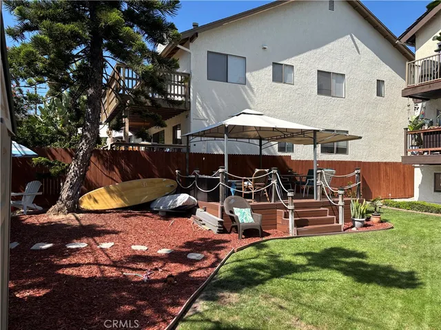 a view of a patio with table and chairs under an umbrella