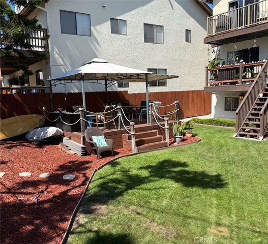 a view of a patio with table and chairs under an umbrella