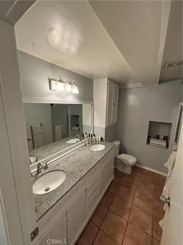 a bathroom with a sink double vanity granite and a mirror