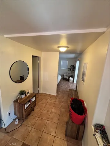 a living room with furniture and a mirror