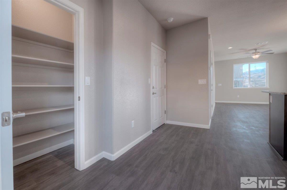 3408 Colonial Downs, Unit LOT 54 Reno, NV 89512 - Photo 11 of 26 a view of an empty room with wooden floor and a window