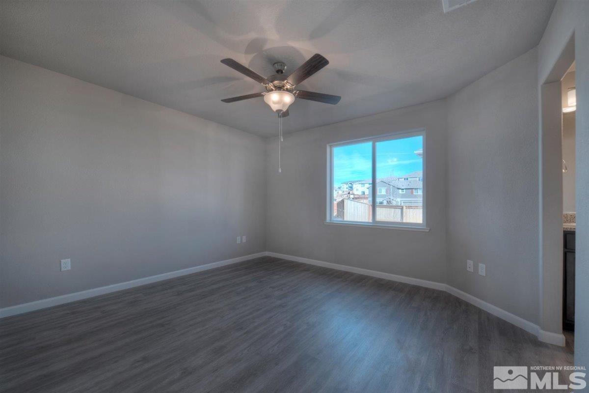 3408 Colonial Downs, Unit LOT 54 Reno, NV 89512 - Photo 14 of 26 wooden floor in an empty room with a window