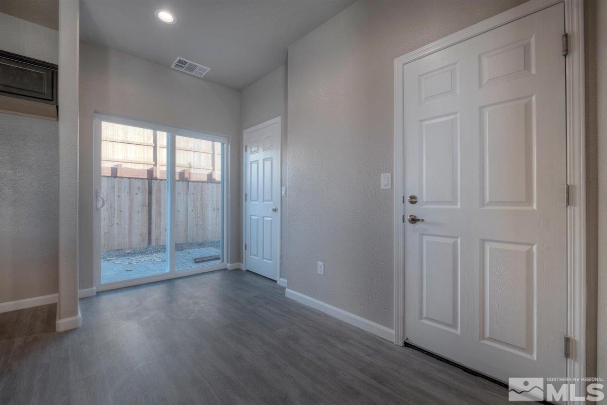 3408 Colonial Downs, Unit LOT 54 Reno, NV 89512 - Photo 10 of 26 an empty room with wooden floor