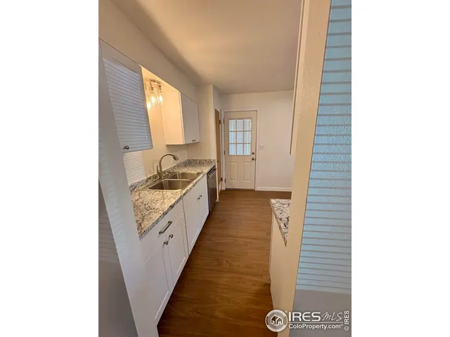 a kitchen with a refrigerator and a stove