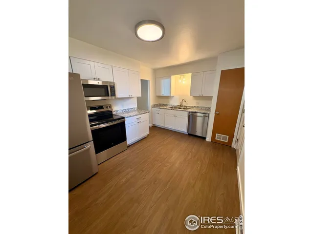 a kitchen with stainless steel appliances a stove top oven
