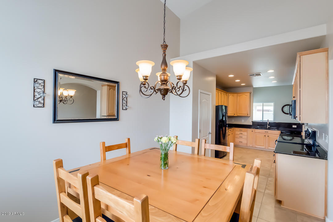 19216 North Lariat Road Maricopa, AZ 85138 - Photo 11 of 40 a dining room filled chandelier and kitchen view