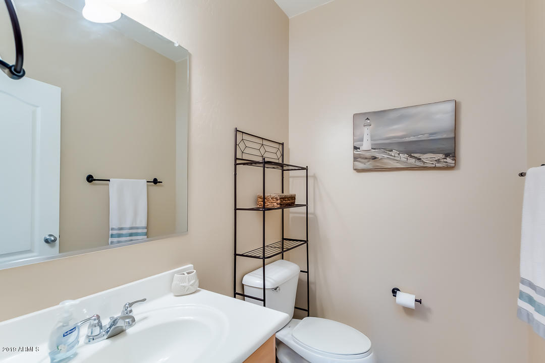 19216 North Lariat Road Maricopa, AZ 85138 - Photo 18 of 40 a bathroom with a toilet sink and mirror
