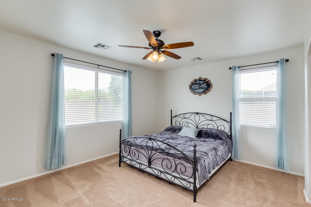 19216 North Lariat Road Maricopa, AZ 85138 - Photo 19 of 40 a bedroom with a large bed and a window