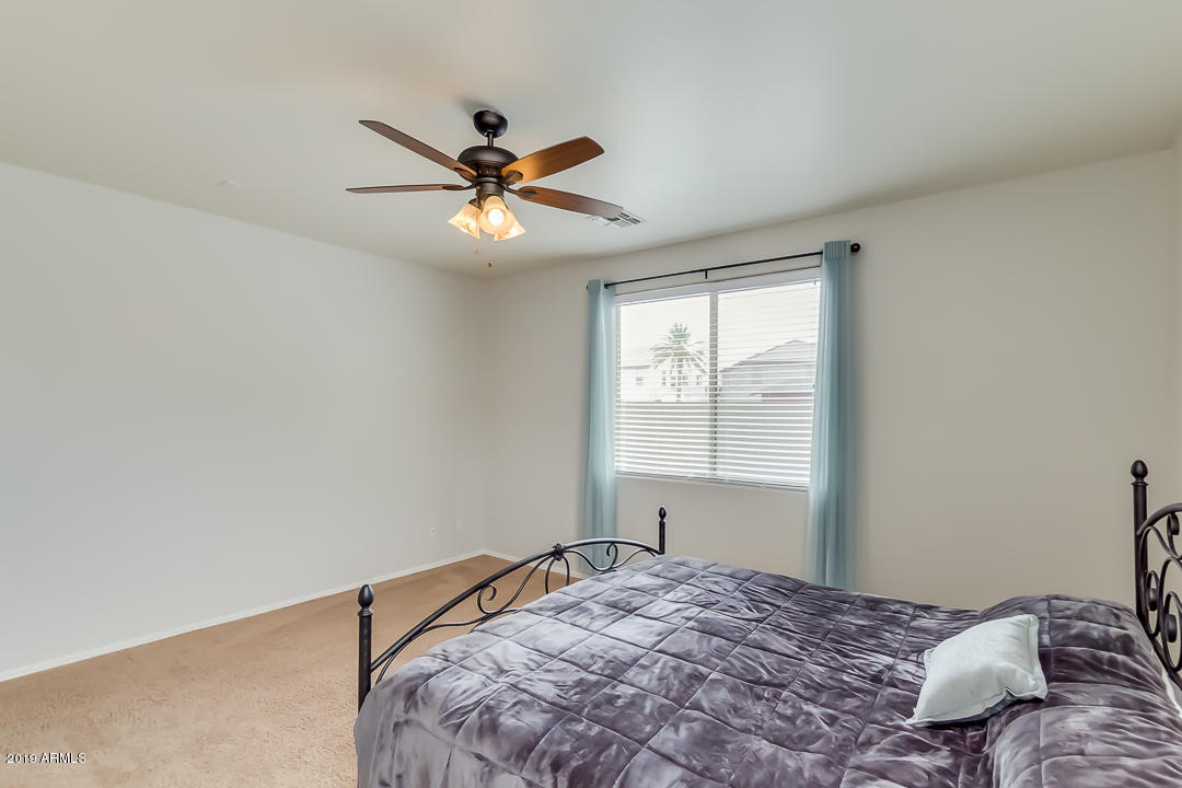 19216 North Lariat Road Maricopa, AZ 85138 - Photo 22 of 40 a bedroom with a bed and a window