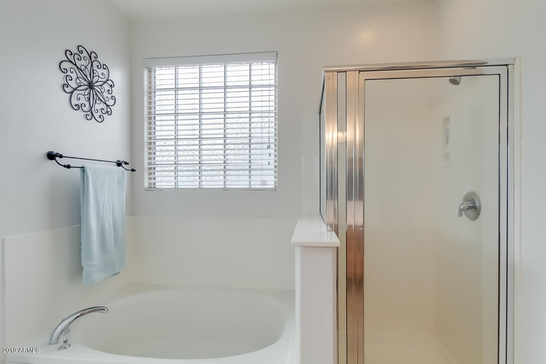 19216 North Lariat Road Maricopa, AZ 85138 - Photo 24 of 40 a bathroom with a bathtub and a shower