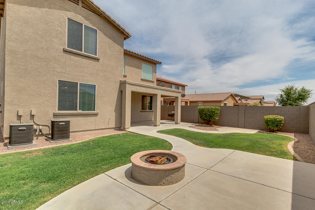 19216 North Lariat Road Maricopa, AZ 85138 - Photo 36 of 40 a view of a backyard with table and chairs and a barbeque