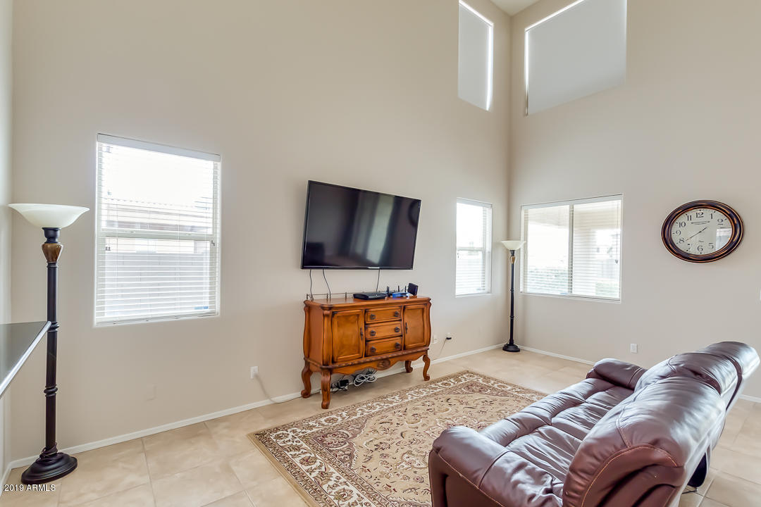 19216 North Lariat Road Maricopa, AZ 85138 - Photo 4 of 40 a living room with furniture and a flat screen tv