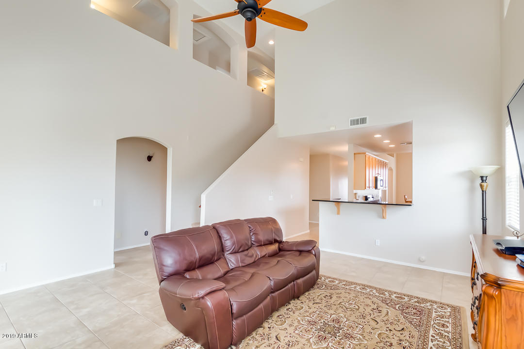 19216 North Lariat Road Maricopa, AZ 85138 - Photo 6 of 40 a living room with furniture and a flat screen tv
