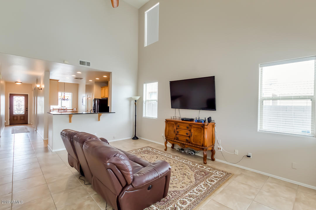 19216 North Lariat Road Maricopa, AZ 85138 - Photo 7 of 40 a living room with furniture and a flat screen tv