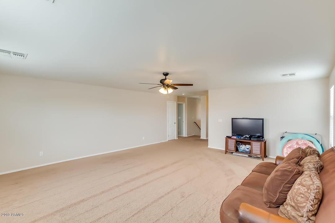 19216 North Lariat Road Maricopa, AZ 85138 - Photo 9 of 40 a living room with furniture and a flat screen tv