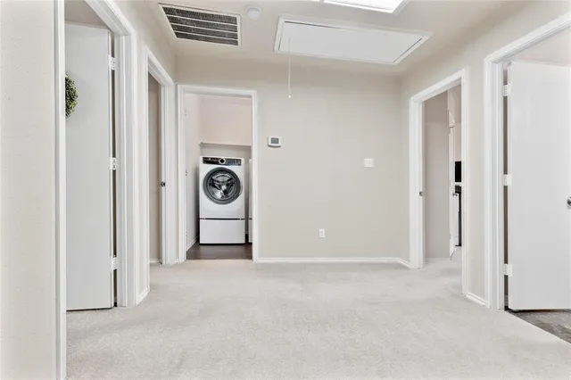a view of a livingroom with washer and dryer