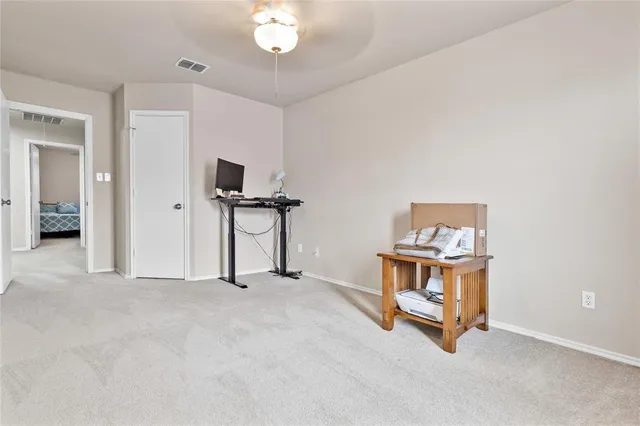 a bathroom with a granite countertop sink a toilet and a mirror