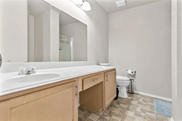 a spacious bathroom with a tub sink and mirror