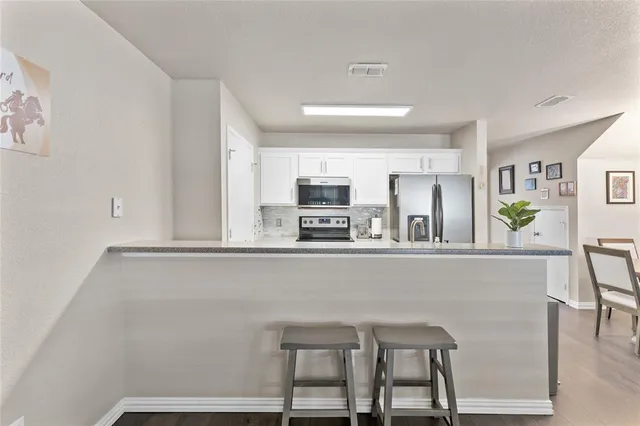 a view of kitchen with cabinets and wooden floor