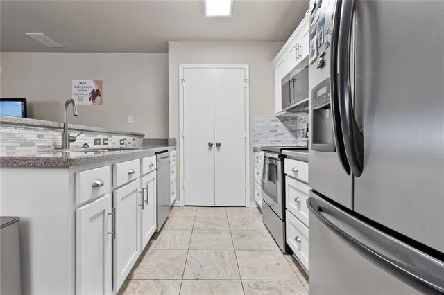 a bathroom with a granite countertop sink a toilet and a mirror