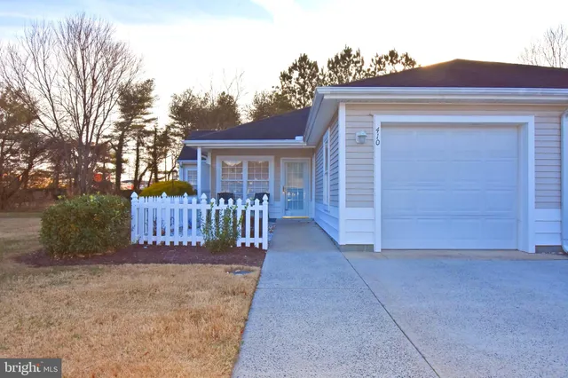 a view of a house with wooden deck and a backyard