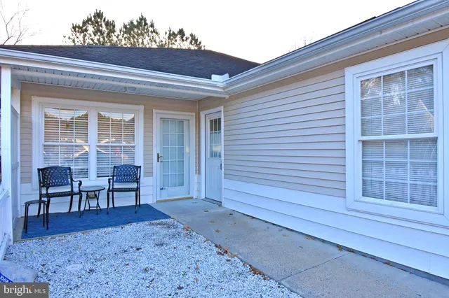 a view of a house with a small yard and wooden fence