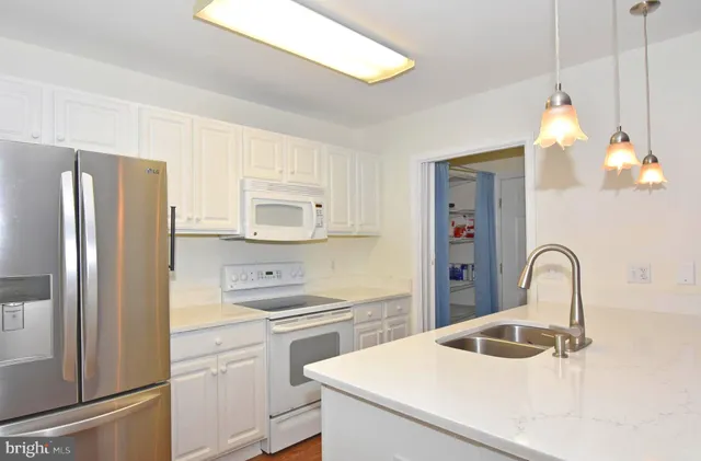 a kitchen with a refrigerator and a sink